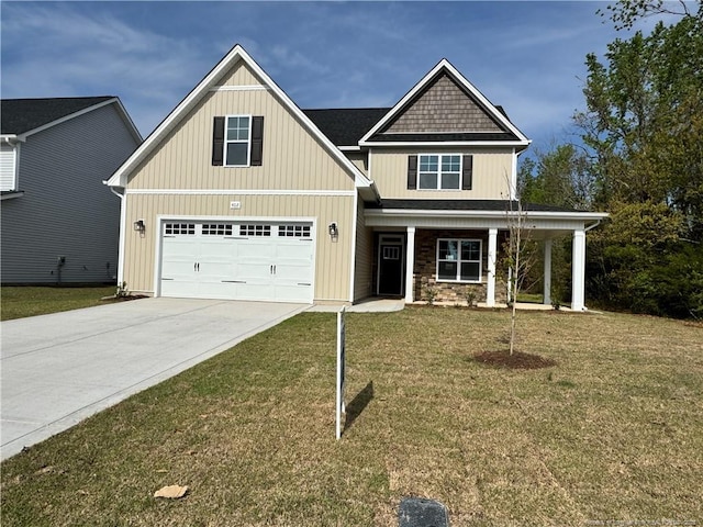 craftsman inspired home with a porch, a front yard, stone siding, an attached garage, and driveway