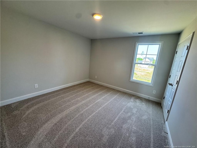 unfurnished bedroom featuring carpet flooring, visible vents, and baseboards