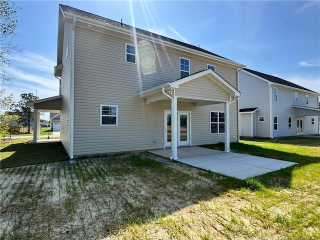 back of house with a patio area and a yard