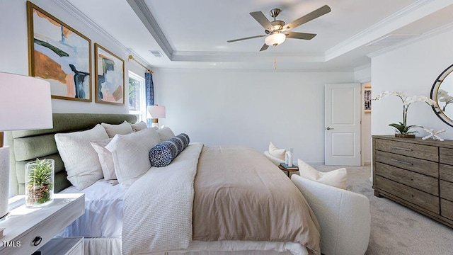 bedroom with a raised ceiling, ceiling fan, light carpet, and ornamental molding