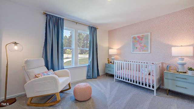 carpeted bedroom featuring a crib