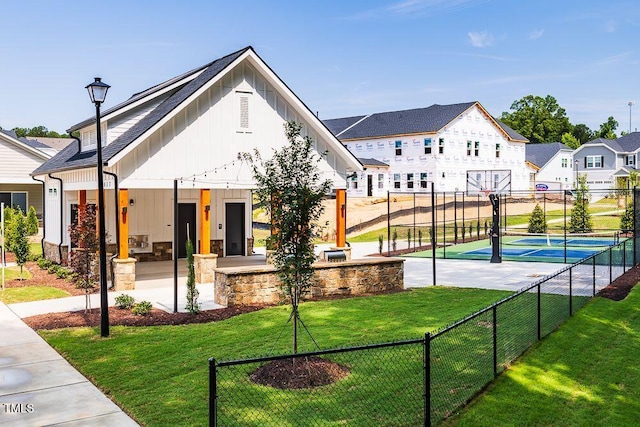 view of basketball court with a lawn and tennis court