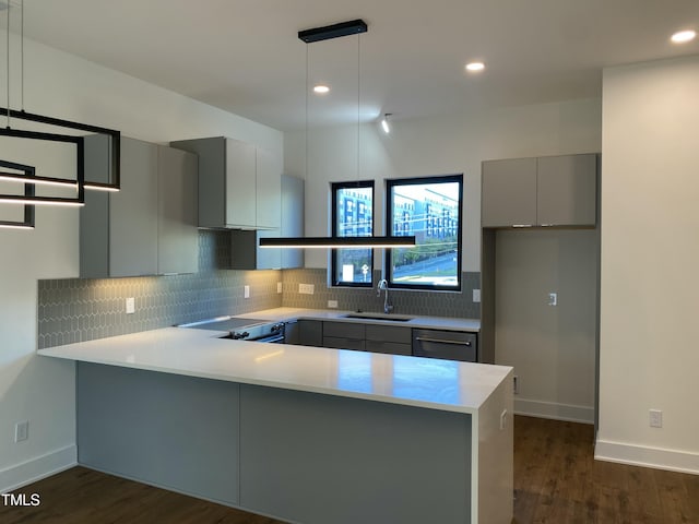 kitchen with kitchen peninsula, decorative light fixtures, and gray cabinets