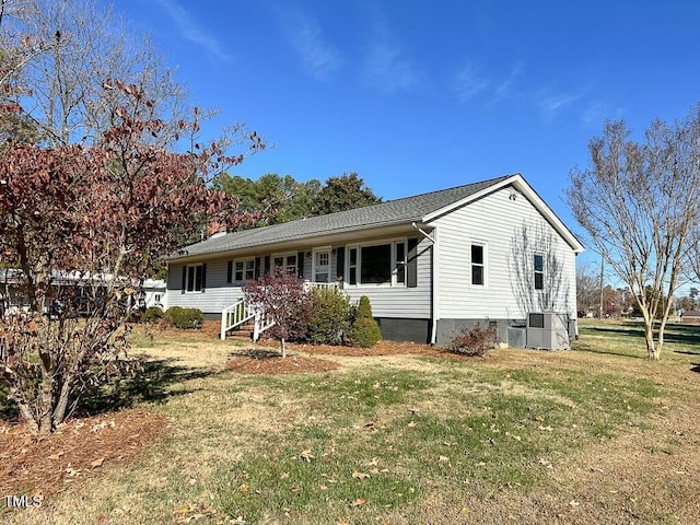 single story home featuring cooling unit and a front yard