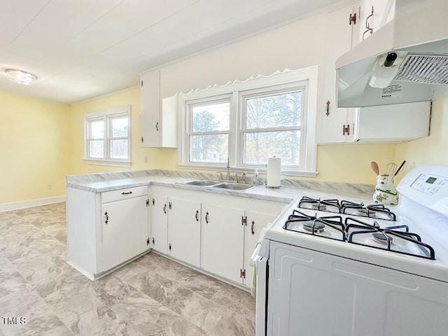 kitchen featuring kitchen peninsula, sink, white cabinets, and white gas range oven