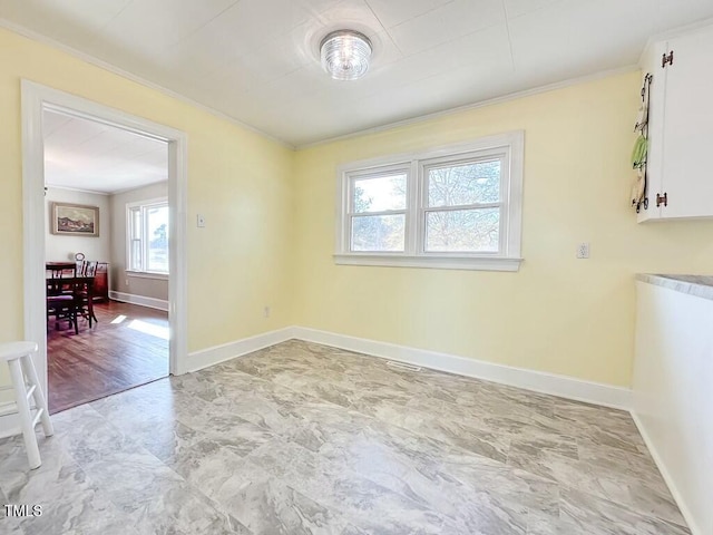 unfurnished dining area featuring crown molding