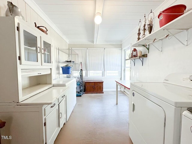 interior space with white cabinets, crown molding, hanging light fixtures, separate washer and dryer, and beamed ceiling