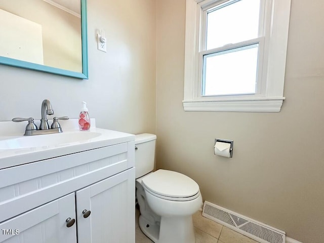 bathroom with tile patterned flooring, vanity, and toilet