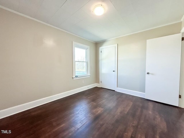 unfurnished room featuring crown molding and dark wood-type flooring