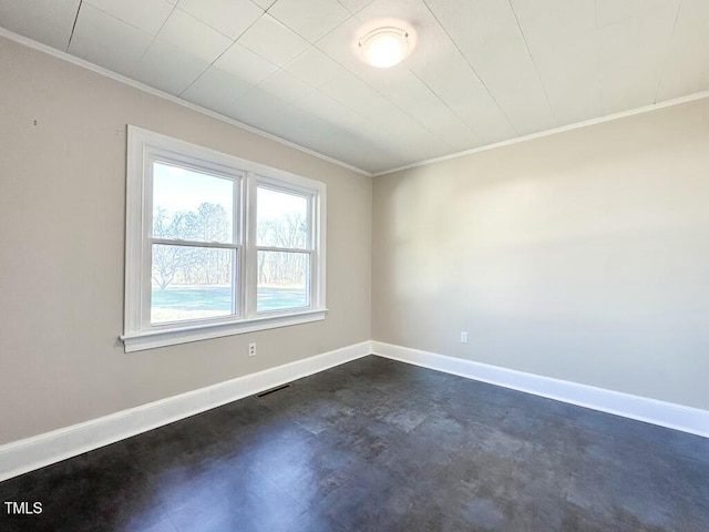 unfurnished room with crown molding