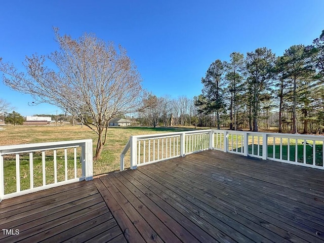 wooden deck featuring a yard