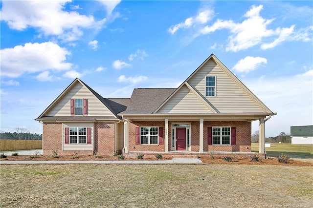 view of front of property featuring brick siding and a porch