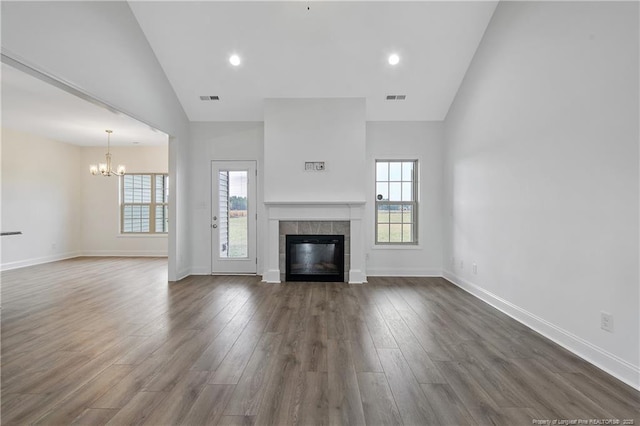 unfurnished living room with a fireplace, visible vents, and dark wood finished floors