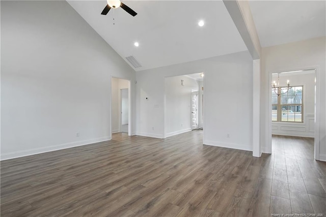 unfurnished living room featuring high vaulted ceiling, ceiling fan with notable chandelier, dark wood-style flooring, visible vents, and baseboards