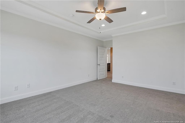 carpeted empty room featuring crown molding, recessed lighting, a raised ceiling, ceiling fan, and baseboards