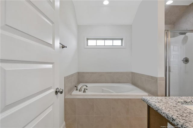 bathroom featuring recessed lighting, a garden tub, a shower stall, and vanity