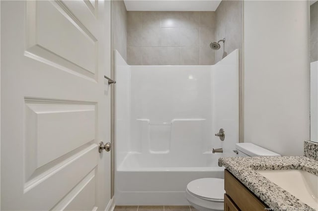 bathroom featuring toilet, tile patterned floors, washtub / shower combination, and vanity