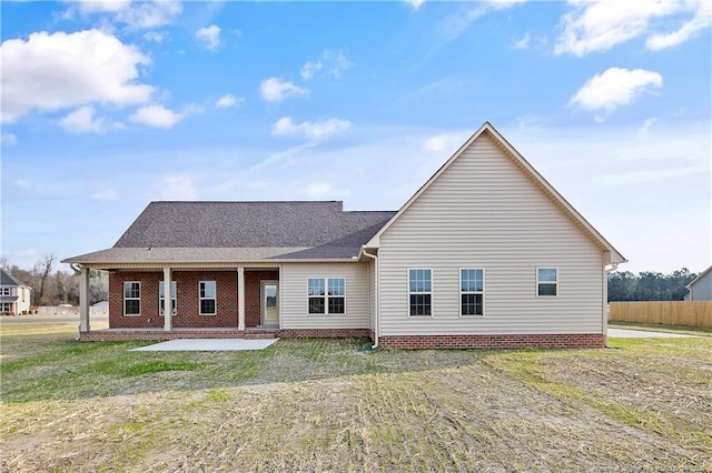 back of property featuring a yard