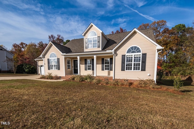 cape cod-style house featuring a porch and a front yard