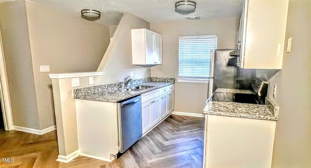 kitchen featuring sink, light parquet floors, range, white cabinets, and stainless steel dishwasher