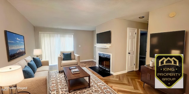 living room featuring light parquet flooring and a textured ceiling