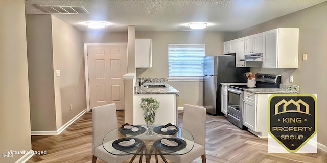 kitchen with white cabinetry, light parquet flooring, and stainless steel electric range oven