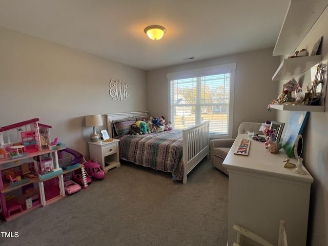 bedroom featuring dark carpet