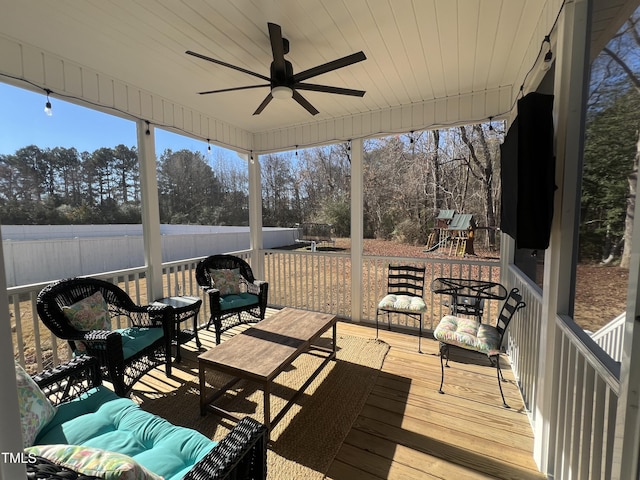 sunroom featuring ceiling fan and wood ceiling