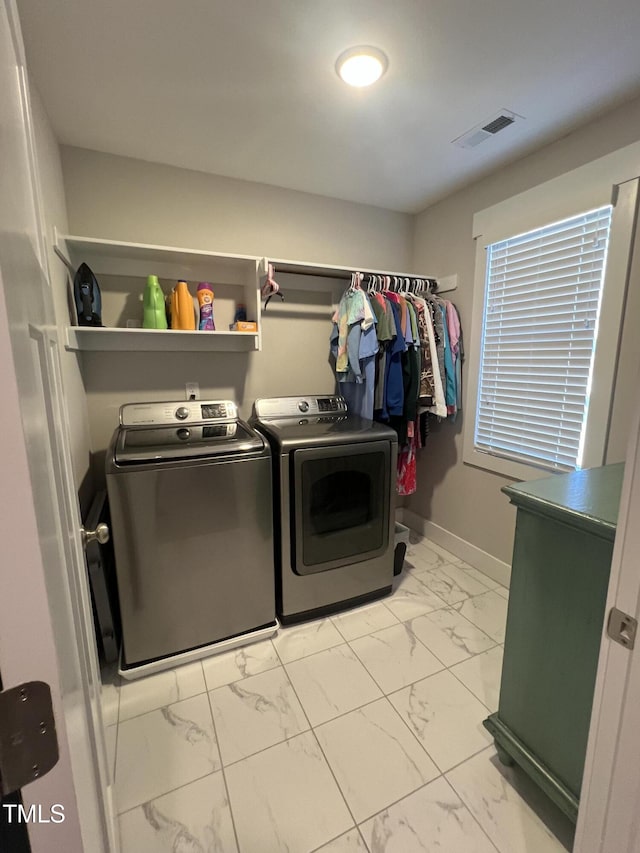 washroom featuring washer and clothes dryer