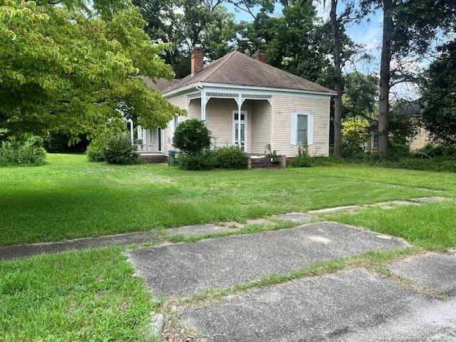 bungalow-style house with a front lawn