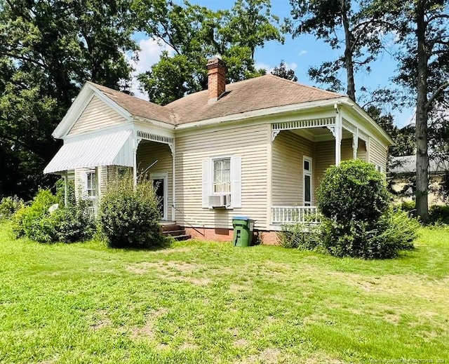 back of property with a lawn and cooling unit