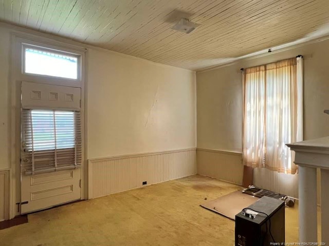 carpeted empty room with wooden ceiling