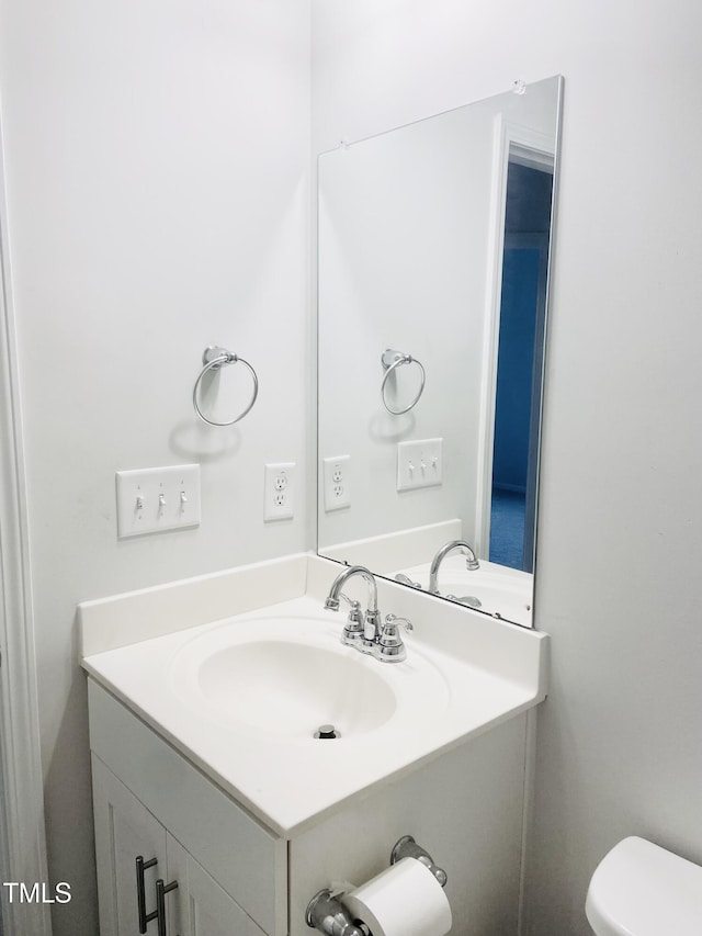 bathroom featuring vanity and toilet