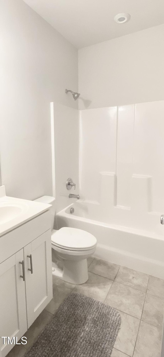 full bathroom with tile patterned floors, vanity, toilet, and shower / tub combination