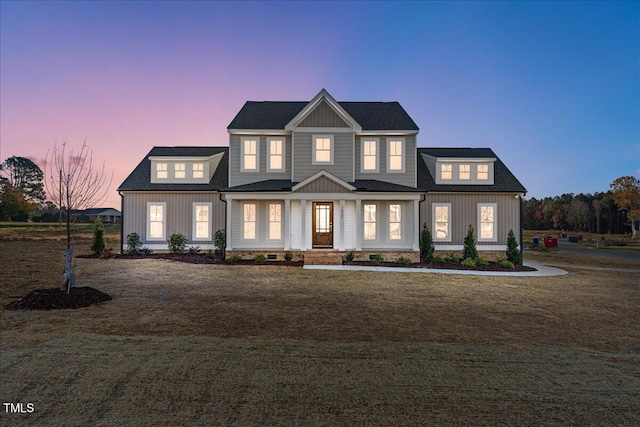 view of front facade with a yard and covered porch