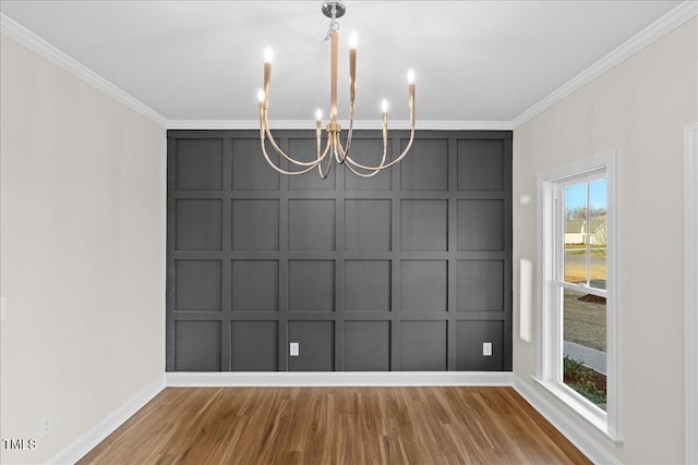 unfurnished dining area featuring crown molding, an inviting chandelier, and hardwood / wood-style flooring