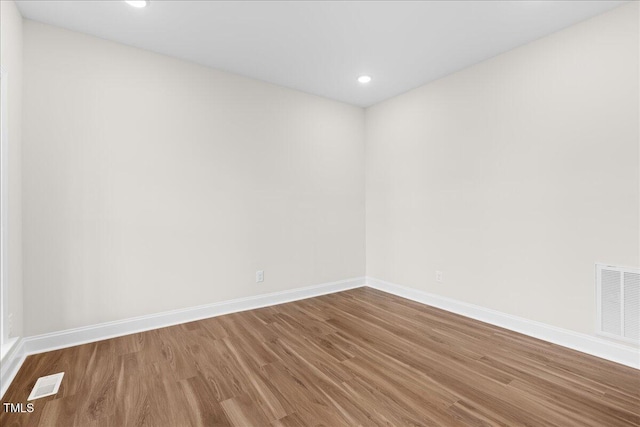 unfurnished room featuring hardwood / wood-style flooring