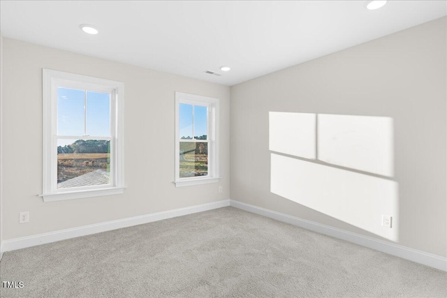 unfurnished room with plenty of natural light and light colored carpet