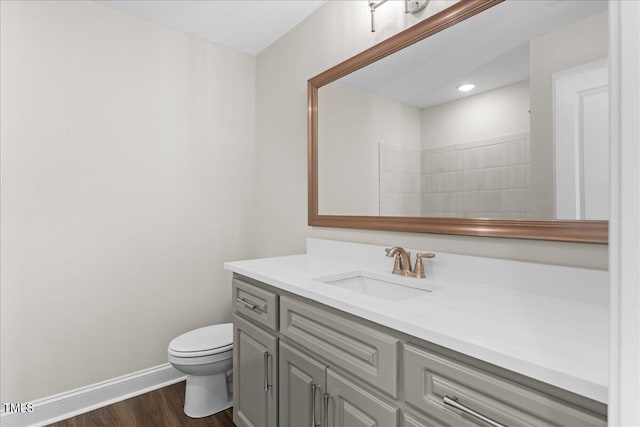 bathroom featuring hardwood / wood-style floors, vanity, and toilet