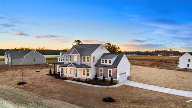 view of front facade featuring covered porch and a garage