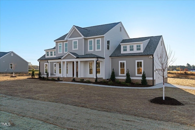 view of front of home with covered porch and a front lawn