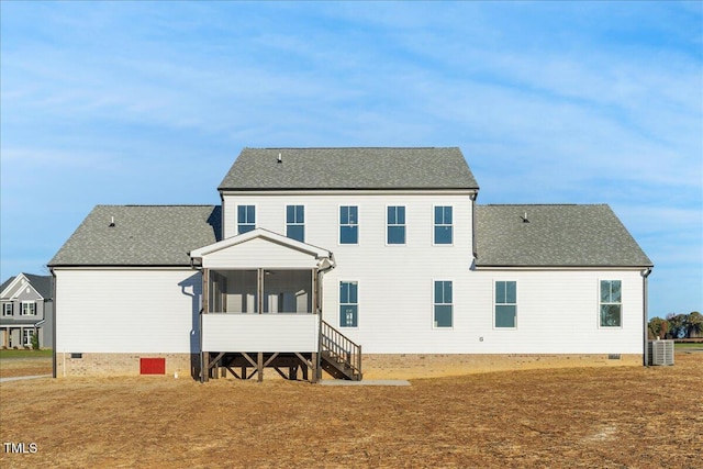 rear view of property featuring a sunroom