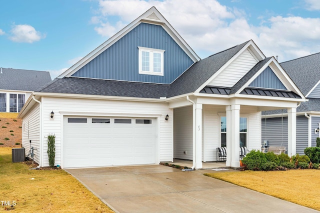 view of front of property featuring central AC unit, a garage, covered porch, and a front lawn