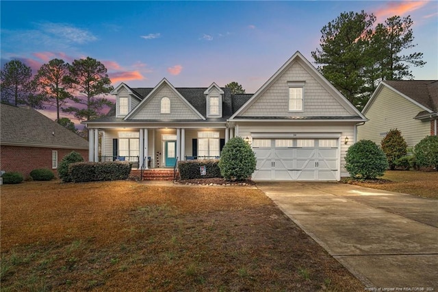 view of front of home featuring a porch and a garage