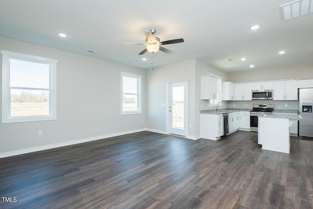 kitchen featuring open floor plan, appliances with stainless steel finishes, dark wood finished floors, and visible vents