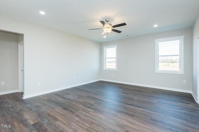 empty room featuring a ceiling fan, baseboards, dark wood-type flooring, and recessed lighting