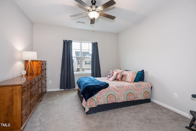 bedroom featuring light colored carpet and ceiling fan