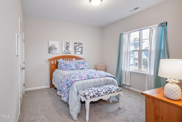 bedroom featuring light carpet