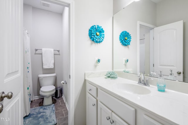 bathroom with tile patterned floors, vanity, and toilet