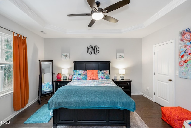 bedroom featuring ceiling fan, a raised ceiling, and dark wood-type flooring